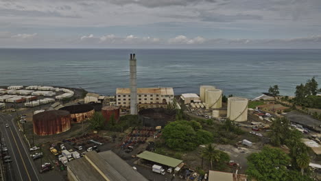 Kahului-Maui-Hawaii-Aerial-v4-drone-flyover-harbor-capturing-cruise-ship,-container-terminals-at-Hobron-point,-shipyard-and-townscape-against-dark-cloudy-sky---Shot-with-Mavic-3-Cine---December-2022