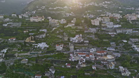 Ravello-Italy-Aerial-v2-cinematic-flyover-and-around-town-center-capturing-picturesque-hillside-neighborhood-and-mountain-landscape-with-lush-vegetations-at-sunset---Shot-with-Mavic-3-Cine---May-2023