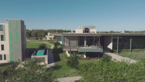 An-aerial-establishing-shot-of-the-University-of-Houston-Clear-Lake-Recreation-and-Wellness-Center,-a-state-of-the-art-fitness-and-recreational-sports-facility-in-Clear-Lake,-Houston,-Texas