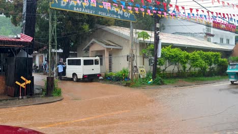 Bunte-Philippinische-Dreiradtaxis-Fahren-Während-Der-Monsunzeit-In-Coron,-Palawan,-Philippinen-Durch-Überschwemmungen-Auf-Nassen-Straßen