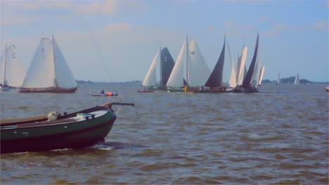 Traditional-sailing-boat-regatta-with-a-historic-cargo-skûtsje-passing-in-front-of-the-camera