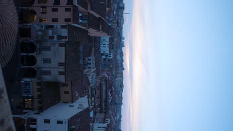 Vertical-shot-of-Mantua-Mantova-cityscape-at-sunset,-zoom-out-reveal