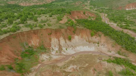 Aerial-drone-shot-of-red-volcano-soil-and-Tsingy-rouge-area-in-Madagascar---long-clip