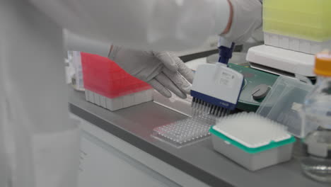Tight-shot-of-scientist-preparing-samples-with-gloved-hands
