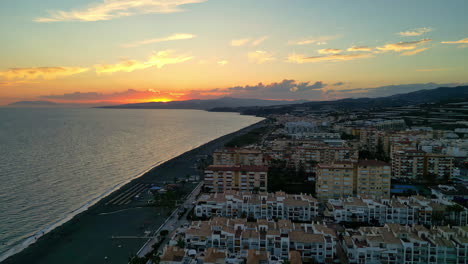Golden-Hour-Over-Coastal-Hotels-in-Malaga:-High-Reversing-Drone-View