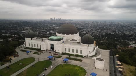 An-aerial-video-of-Griffith-Observatory-showcases-both-its-side-and-frontal-perspectives-against-a-backdrop-of-the-expansive-cityscape