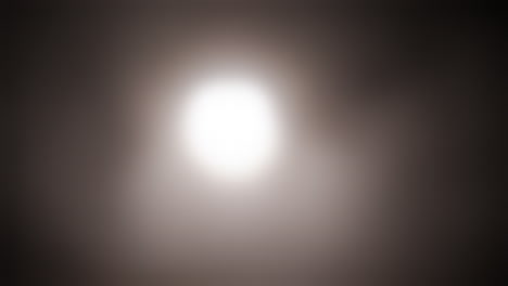 Strange,-glowing,-alien,-UFO-orb-light,-ghost-or-moon-light-in-fog-and-smoke-for-halloween-or-science-fiction,-sci-fi-background