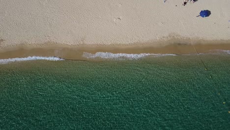 Aerial-birdseye-shot-over-the-wonderful-santa-maria-beach-in-cabo-san-lucas-with-calm-waves-of-turquoise-sea,-clean-sandy-beach-with-vacationers-and-tourists-on-a-sunny-summer-day-on-vacation