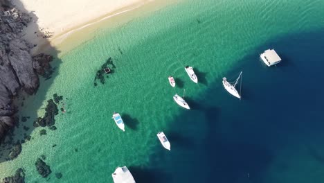 Aerial-over-Playa-Balcóncito-with-boats-and-yachts-in-green-waters