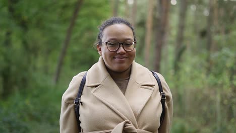 Portrait-shot-of-african-european-woman-smiling-in-the-forest