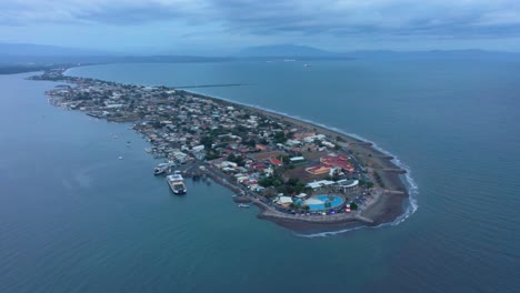 Pequeña-Ciudad-Costera-Costarricense-De-Puntarenas-En-Un-Día-Nublado,-Paso-Elevado-De-Drones-De-4k