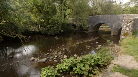 wide-shot-of-stone-bridge-at-Wetton-mill-over-the-river