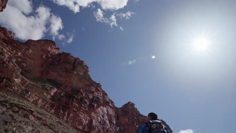 Photographer-taking-in-his-surroundings-during-a-hike-in-the-southwestern-deserts-of-Arizona-and-the-Grand-Canyon-on-a-sunny-afternoon-outdoors