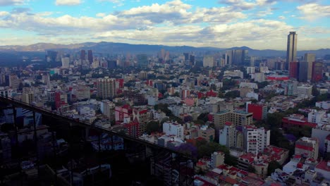 stunning-Mexico-City-cityscape-urban-neighborhood-skyline-tall-buildings-mountains-cloudy-sky-morning-view-revealing