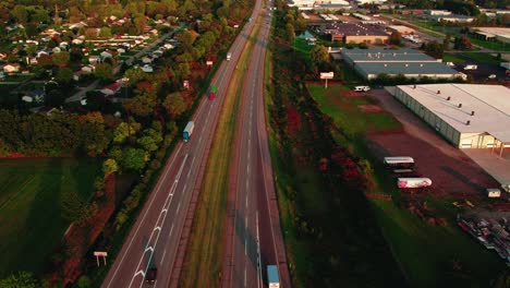 aerial-view-of-interstate-highway,-capturing-semi-trucks-in-motion,-commercial-transport-and-logistics-business
