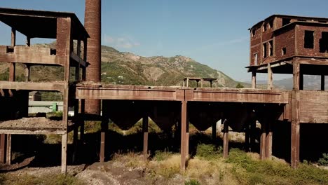 Drone-view-of-the-abandoned-metal-factories-at-Kombinati-Metalurgjik,-Albania,-Balkans,-Europe-Dolly-shot,-pull-out