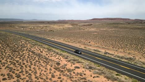 An-aerial-Drone-Shot-of-a-Ford-Mustang-Car-Vehicle-traveling-on-the-highway-of-Route-66