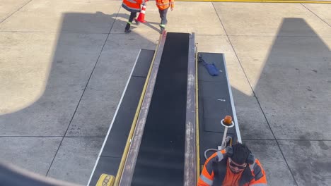 Passenger-POV-Baggage-unloading-or-loading-car-approach-airplane-side-at-Montevideo-Carrasco-International-airport