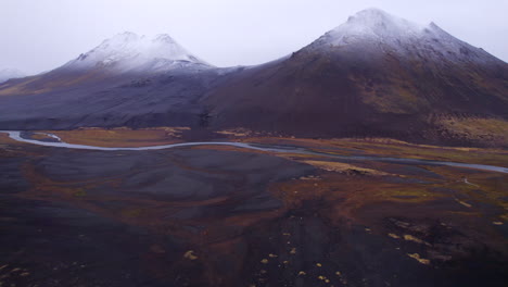 Epic-snow-capped-black-sand-volcanoes-seen-from-N1-ring-road-in-Iceland