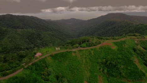 Aerial-of-a-dramatic-and-gloomy-day-of-a-ridgeline-road-in-a-tropical-forest