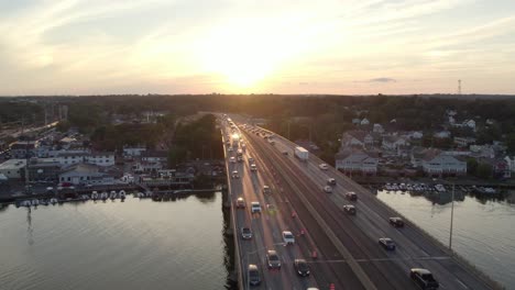 Drone-Shot-Tracking-Forward-over-Interstate-on-Bridge-at-Golden-Hour,-with-Moderate-Heavy-Traffic