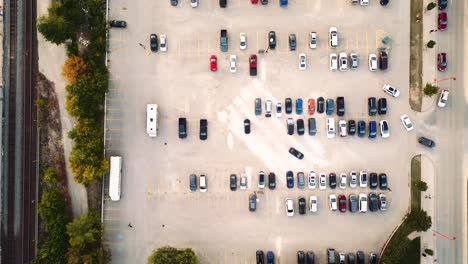Overhead-Top-Down-Aerial-Drone-Shot-of-a-Light-Grey-Cement-Parking-Lot-Full-of-Colorful-Cars-and-People-Walking-in-a-Outdoor-Shopping-Center-in-Winnipeg-Manitoba