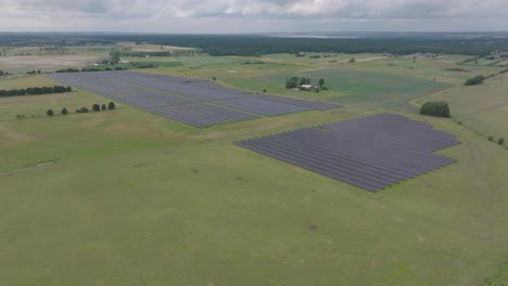 Large-solar-cell-park-in-rural-Sweden-on-green-farm-field-during-bad-weather