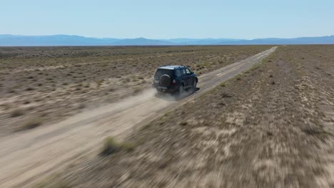 Following-A-Car-Off-Roading-In-Arid-Landscape-Near-Charyn-Canyon-National-Park,-Kazakhstan