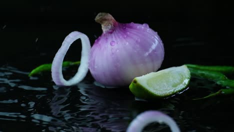 Whole-Red-Onion-And-A-Slice-With-Sliced-Lime-In-Puddle-Of-Water