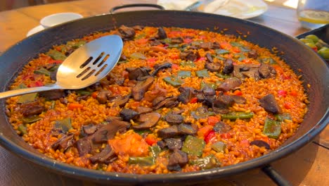 Traditional-Spanish-Paella-dish-with-vegetables-in-a-restaurant,-tasty-cooked-rice-with-vegetables,-Marbella-Spain,-4K-shot