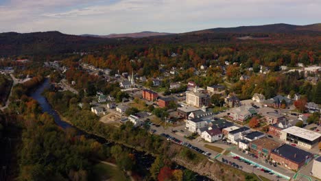 Aerial-Shot-Of-A-Quiet-New-England-Town-Surrounded-By-Fall-Color-Landscape
