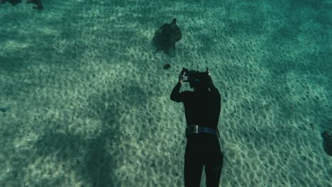 Turtle-gracefully-swimming-through-ocean-water-captured-on-diver’s-camera