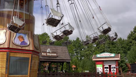 People-enjoying-swing-carousel-in-Djurs-amusement-park,-Denmark