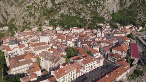 Aerial:-Kotor,-Montenegro-with-historic-buildings-and-mountainous-backdrop