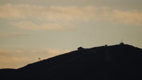 Silhouette-Of-A-Ski-Mountain-And-Chairlift-At-Sunset