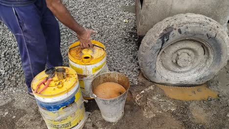 Video-Shot-Of-An-Engineer-Ultratech-Water-Proofing-Chemicals-are-added-to-cement-concrete-for-new-building-construction