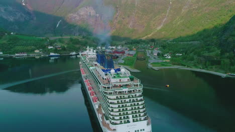Drone-shot-circling-the-Britannia-cruiseliner-arriving-to-Flam,-in-Central-Norway