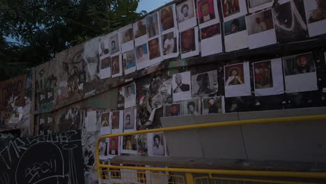 Wide-view-of-facial-portraits-exhibited-on-a-downtown-fence-in-Toronto