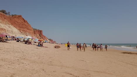 Gente-Disfrutando-De-Un-Día-En-La-Playa-De-Arena-Blanca-De-Praia-Da-Falesia.