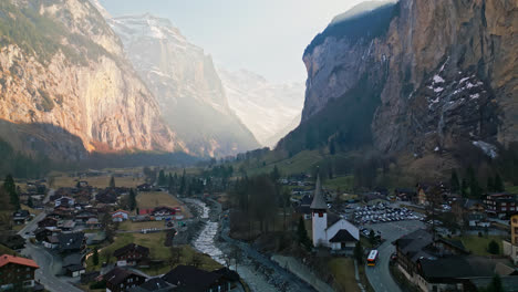 Sun-rays-cut-down-deep-into-the-valley-above-the-Swiss-town-of-Lauterbrunnen-hidden-in-the-shadows