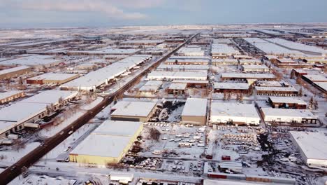 Aerial-view-of-a-sunny-winter-day-in-a-Canadian-industrial-area-covered-with-snow