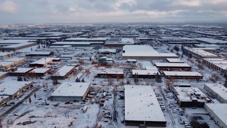 Frozen-industrial-area-in-North-America,-covered-in-snow---captured-from-a-drone-view