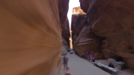 Walking-through-the-siq-to-view-the-Treasury-in-Petra,-Jordan---hyper-lapse