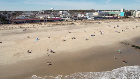 Rehoboth-Beach-Delaware-sunny-day-drone-flyover-beach-to-downtown-long-shot