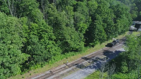 An-Aerial-View-of-an-Antique-Shay-Steam-Locomotive-Backing-Up-to-Approach-a-Station-in-Slow-Motion-on-a-Sunny-Summer-Morning