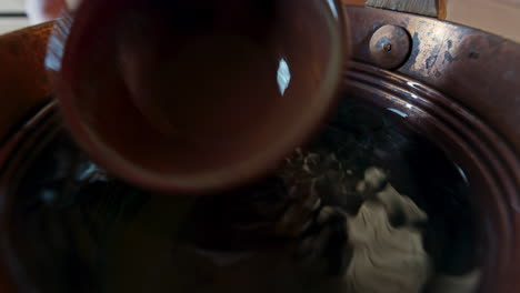 Wide-angle-close-up-of-the-water-surface-in-the-water-bucked-used-in-the-sauna-called-a-kip-or-pail