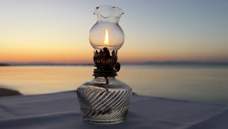 Vintage-table-oil-lamp-against-the-backdrop-of-the-sunset