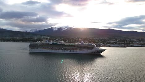 Aerial:-huge-cruise-ship-navigating-along-the-scenic-coastline-of-Iceland-during-sunset