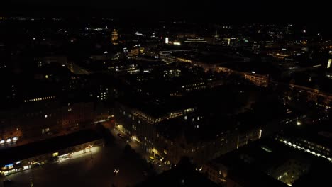 Illuminated-Helsinki-buildings-on-dark-black-night-flyover-aerial