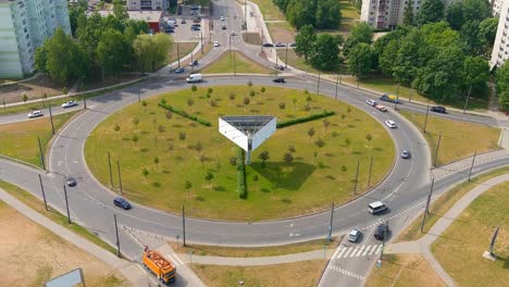 Massive-roundabout-and-old-apartment-buildings-in-Kaunas,-aerial-view